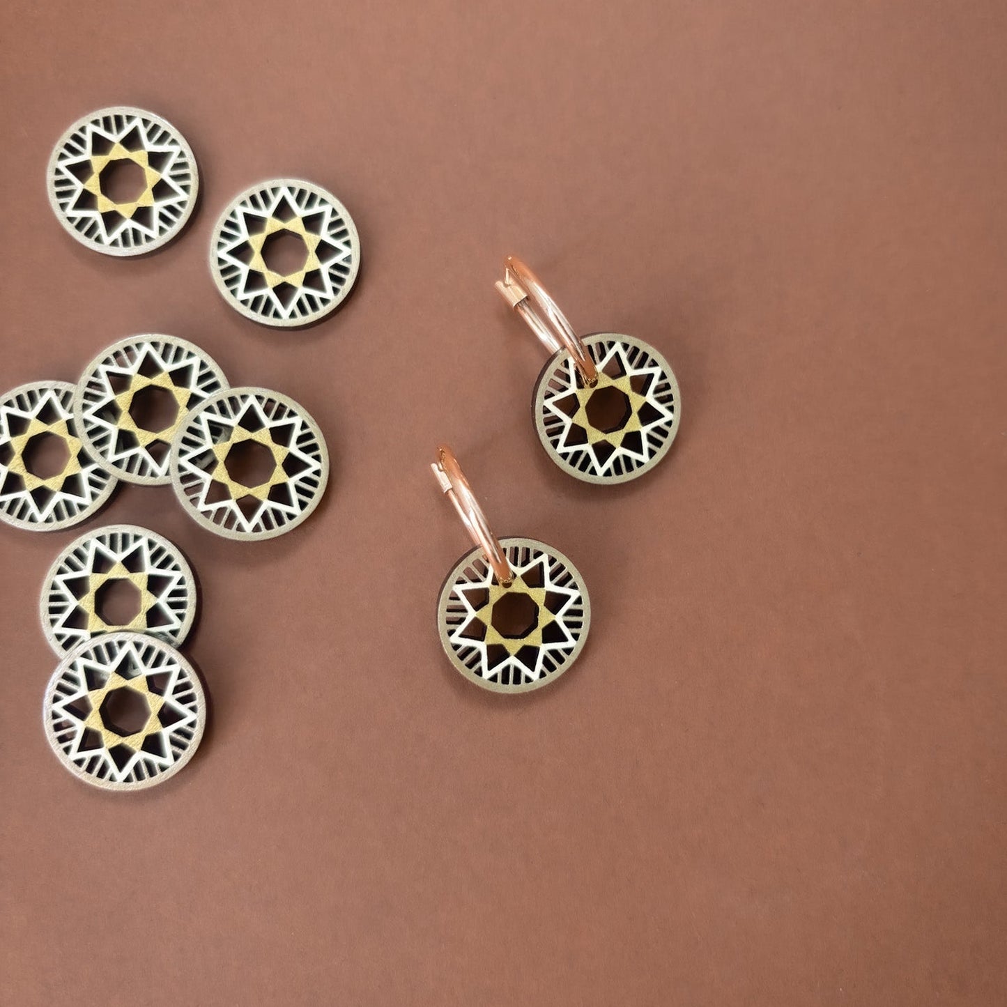 Decorative circular ornaments with intricate patterns on a brown background