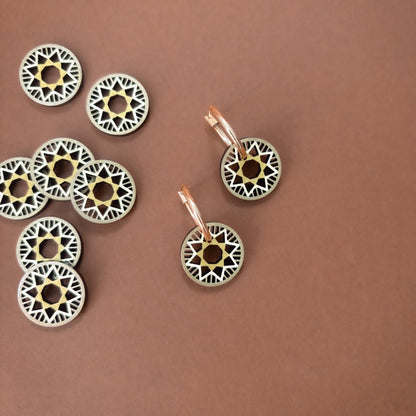 Decorative circular ornaments with intricate patterns on a brown background